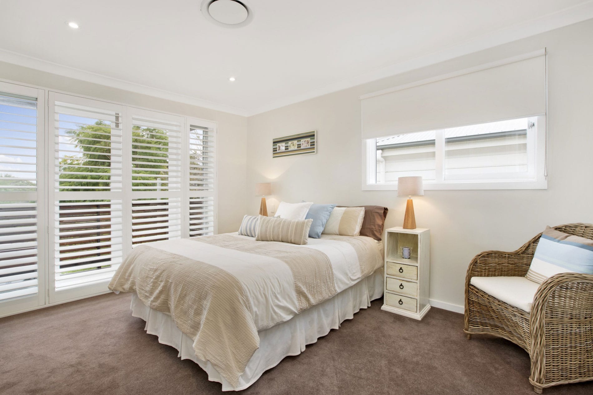 Bedroom with blockout roller blinds and shutters