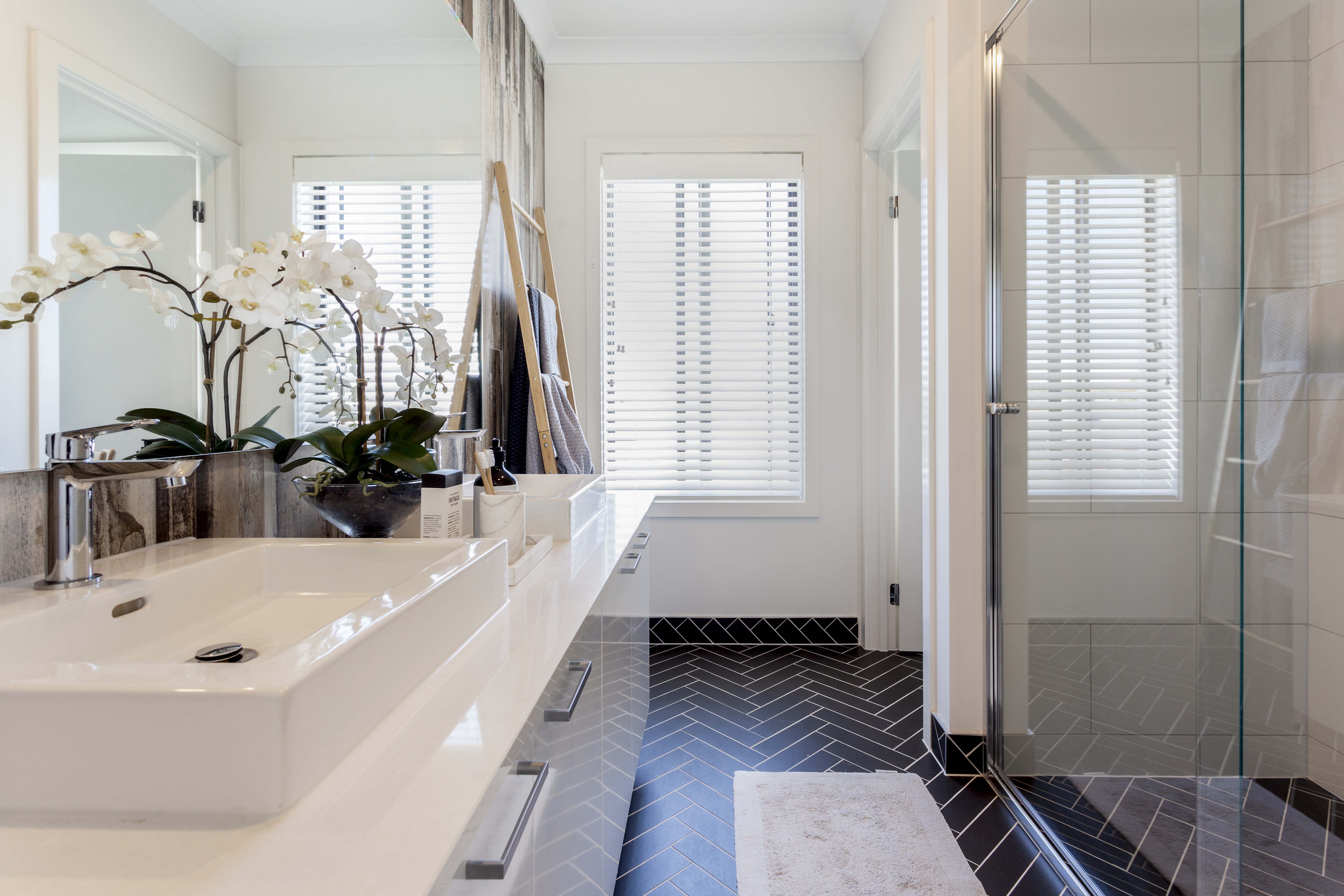White venetian blinds on two ensuite windows, tilted for privacy and daylight