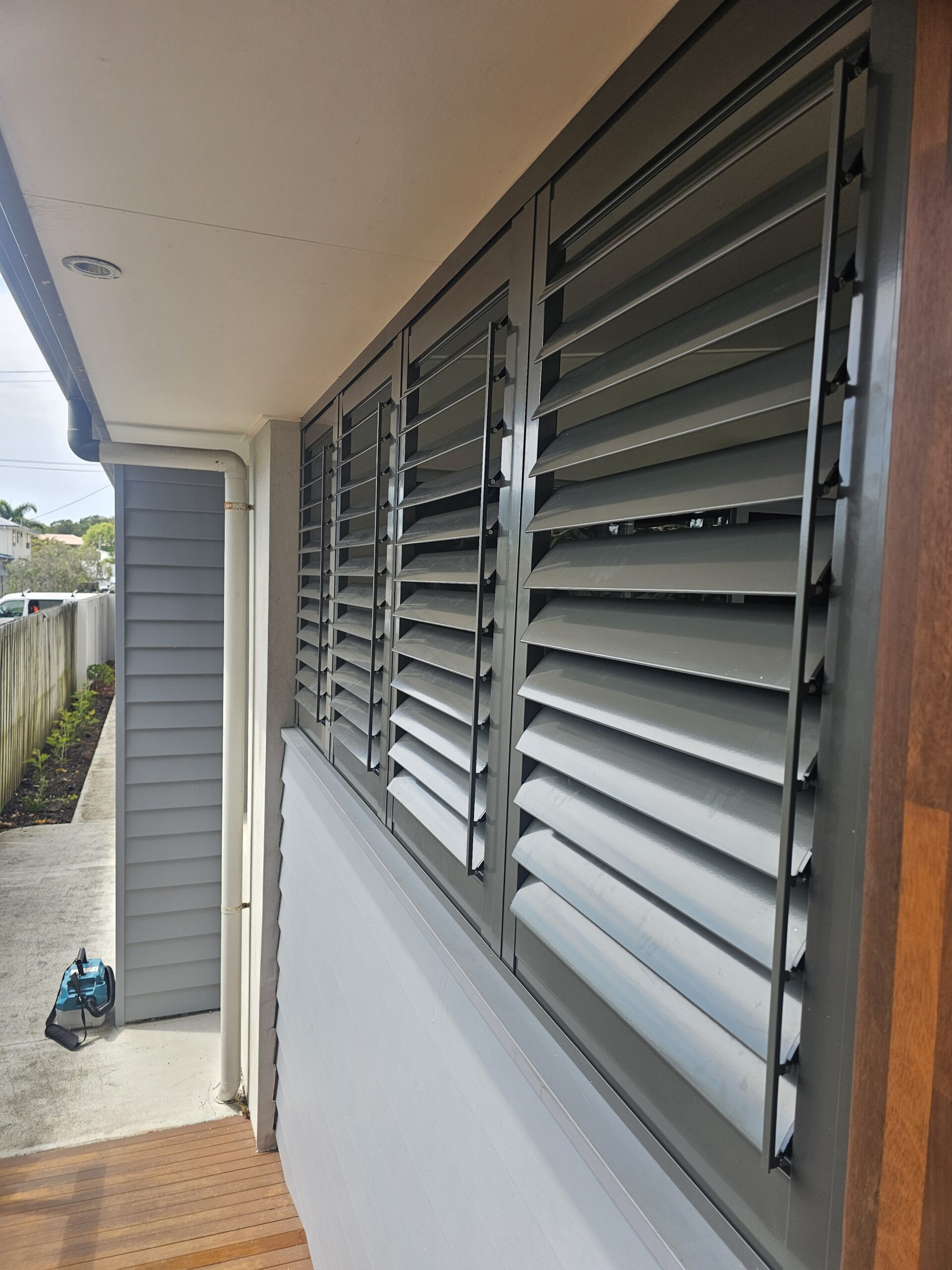 External aluminium shutters installed on a Gold Coast home by Gold Coast Blinds and Shutters