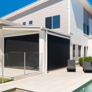 Modern Gold Coast home with black outdoor blinds shading a poolside patio