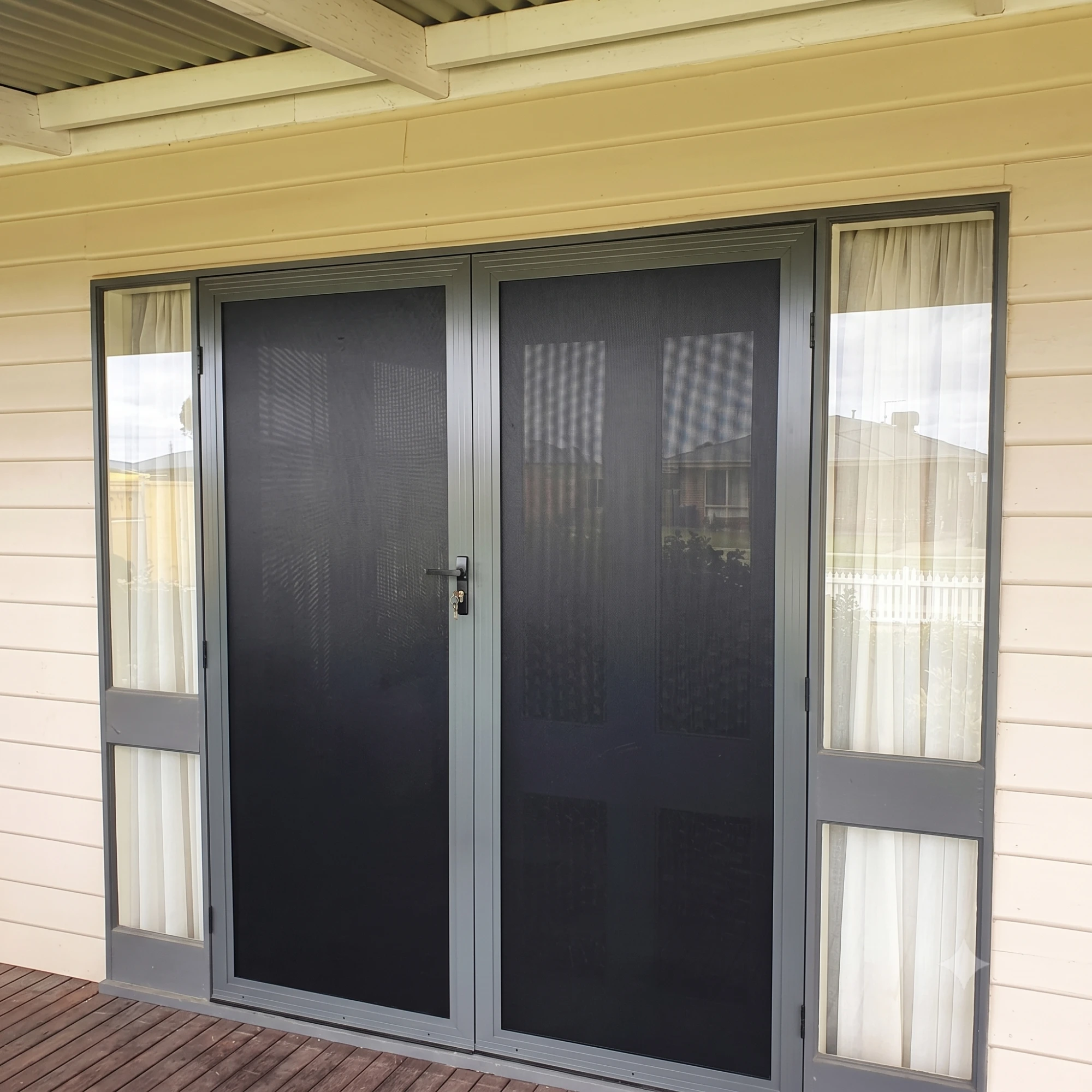 Custom double hinged security screen doors manufactured and installed by Gold Coast Blinds and Shutters
