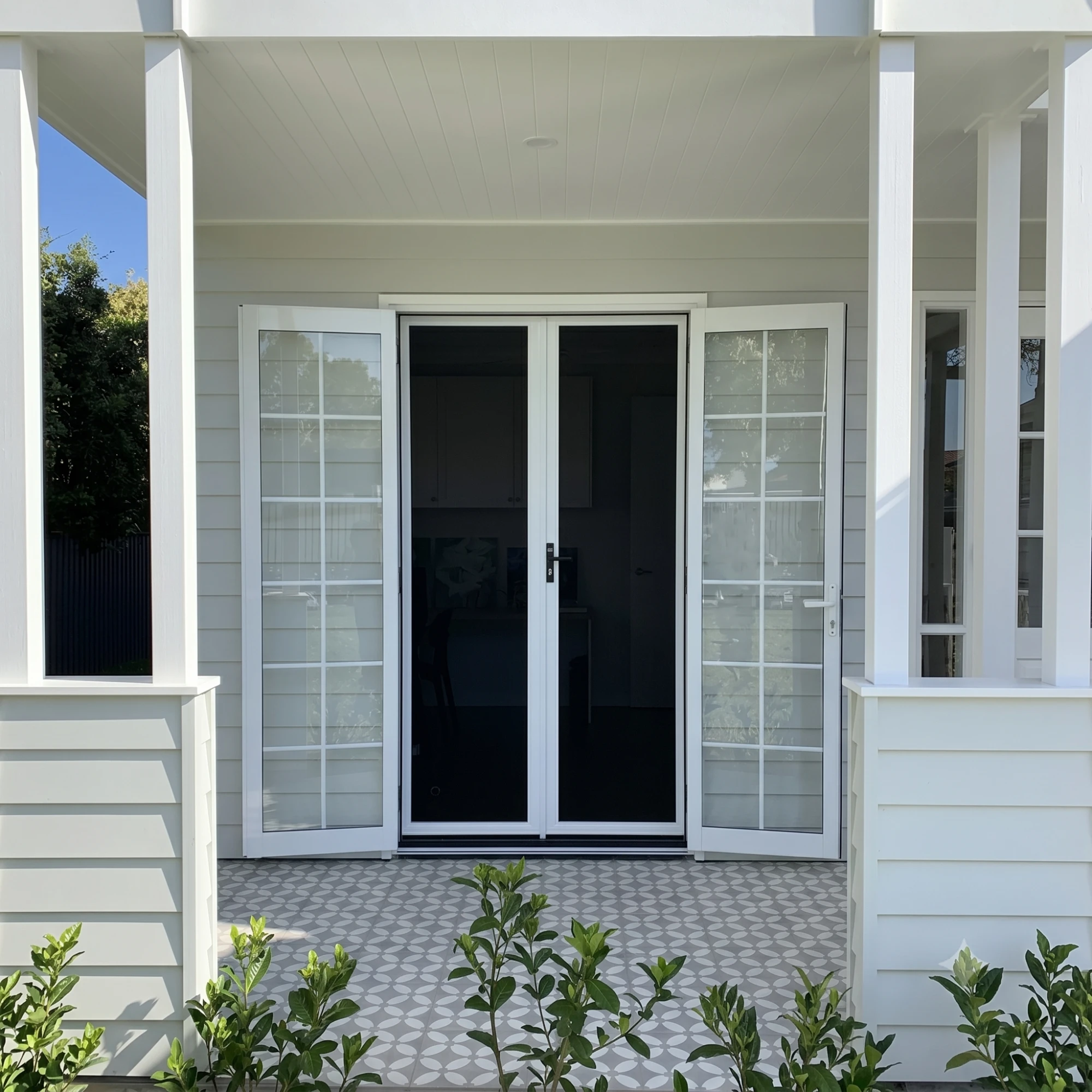 Hamptons-style front entry with custom security screens by Gold Coast Blinds and Shutters