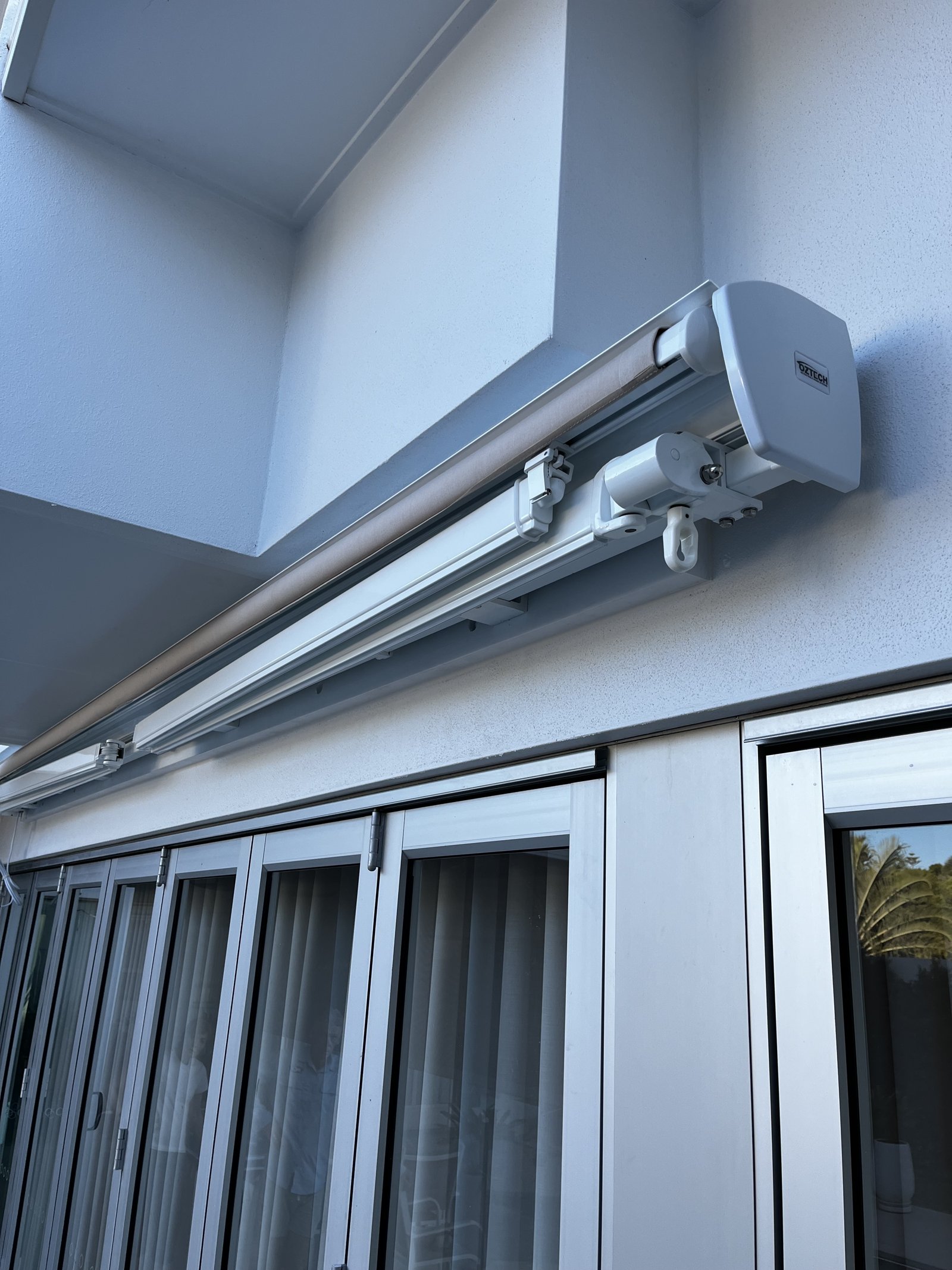 Close-up of a motorised retractable awning motor and mount bracket installed by Gold Coast Blinds and Shutters